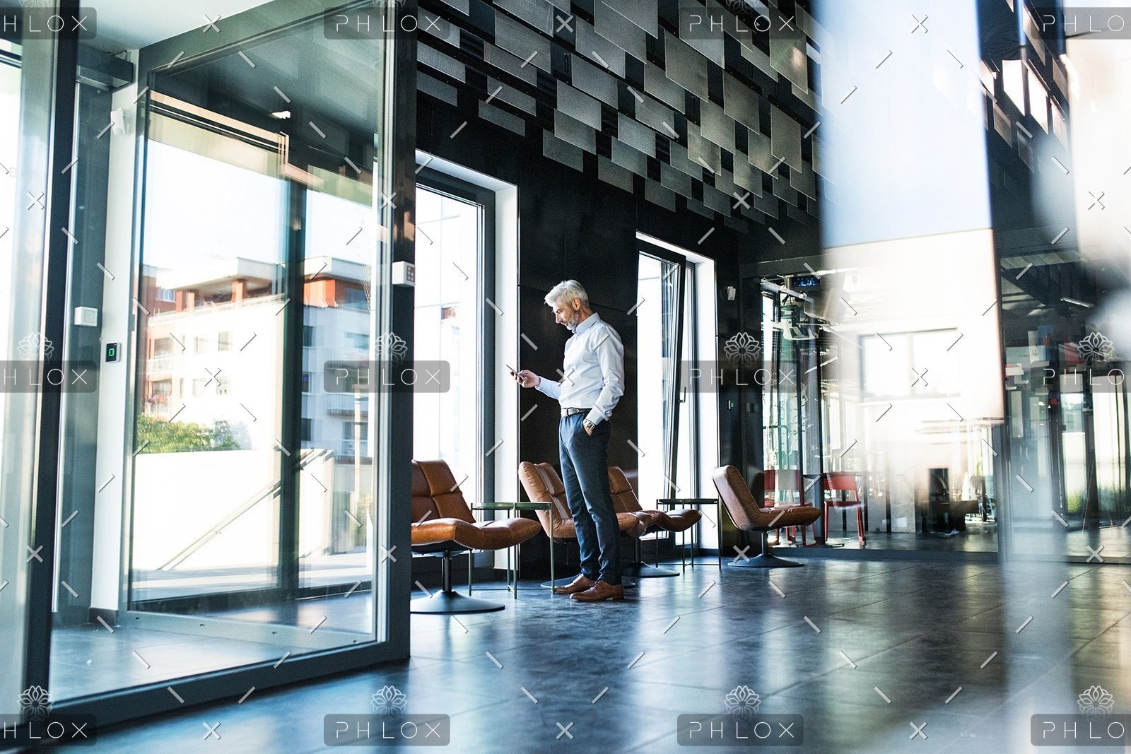 demo-attachment-30-Mature-businessman-with-smartphone-in-the-office.